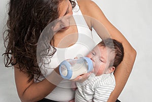 Baby drinking milk of her bottle