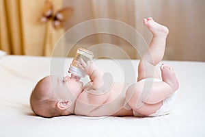 Baby drinking water from bottle photo