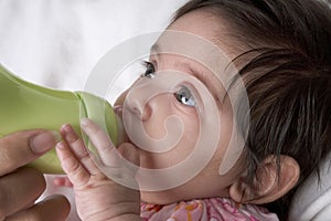 Baby drinks from baby-bottle