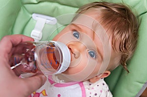Baby drinks from bottle