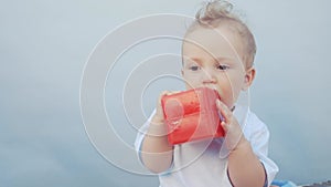 baby drooling bubbles on the lips a toddler play with a cube at home. little boy son fun portrait close-up. little baby