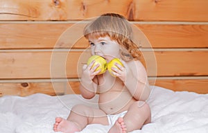 Baby eat apples. Kid eating fruit. Healthy nutrition for kids. Solid food for infant.