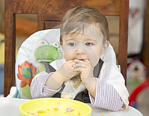 Baby eating with hands