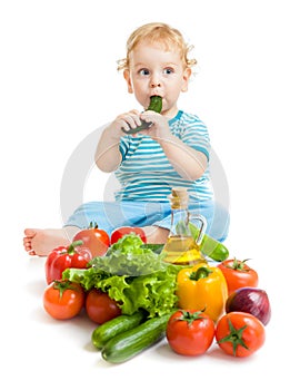 Baby eating healthy food vegetables on white