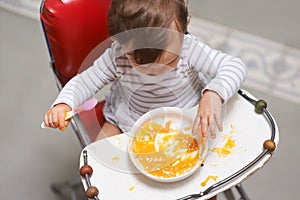 Baby eating, high chair and food, nutrition and health for childhood development and wellness. Healthy, growth and