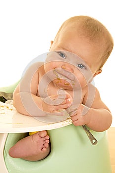 Baby eating with messy face