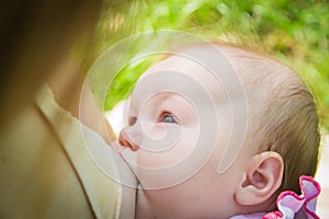 Baby eating mother`s milk. Mother breastfeeding baby. Beautiful mom breast feeding her newborn child