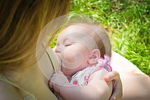 Baby eating mother`s milk. Mother breastfeeding baby. Beautiful mom breast feeding her newborn child