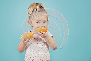 Baby eating an orange