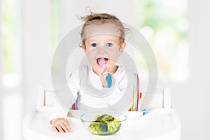 Baby eating vegetables. Solid food for infant