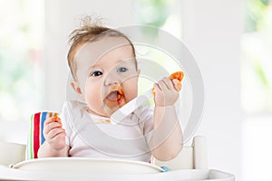 Baby eating vegetables. Solid food for infant