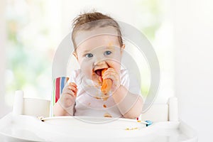 Baby eating vegetables. Solid food for infant