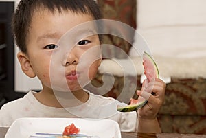 Baby eating watermelon