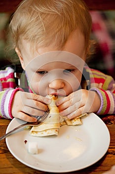 Baby eats the delicious pancakes