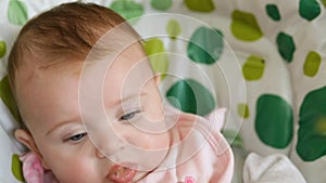 Baby eats first meals with fruit.