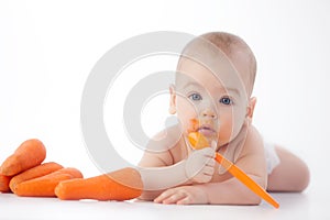 Baby eats mashed carrots