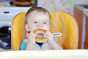 Baby eats round cracknel