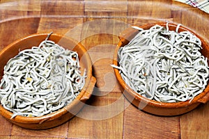 Baby eels or substitute for elvers served in a ceramic dish. Typ