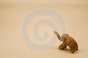 Baby elefant made of wood on a light background