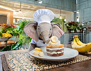 Baby elephant chef decorating delectable banana cake in the kitchen