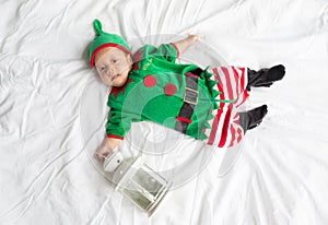 Baby in elf costume for christmas holiday on white