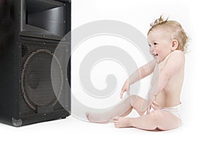 Baby enjoying sound in front of loudspeaker