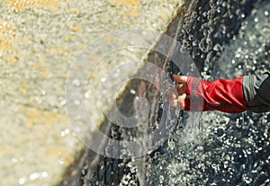 A baby explores a fountain