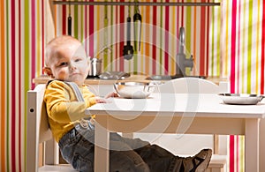 Baby family boy sit on toy kitchen