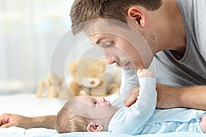 Baby and father playing together