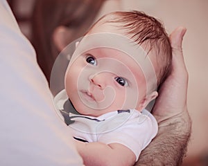 Baby on father's hand