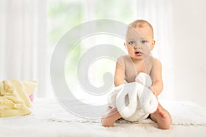 Baby with a favorite soft toy in his hand