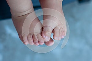 Baby feet on blue background