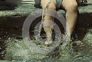 Baby with feet in the cool water