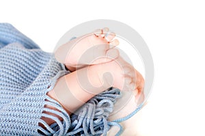 Baby feet covered in blue wrap isolated background