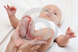 Baby feet cupped into mothers hands