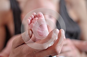 Baby feet in father hands. Dad and his child. Happy Family concept. Beautiful conceptual image of parenthood