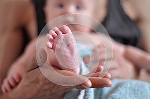Baby feet in father hands. Dad and his child. Happy Family concept. Beautiful conceptual image of parenthood