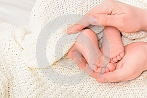 Baby feet in male hands with soft background, close-up. Father& x27;s day concept