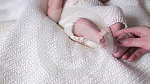 Baby feet massage. Newborn feet in mother hands