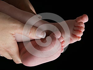 Baby feet and mom's hands