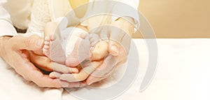 Baby feet in mother and father`s hands. My parents and their child. Happy Family concept. Beautiful conceptual image