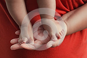 baby feet on mother hand