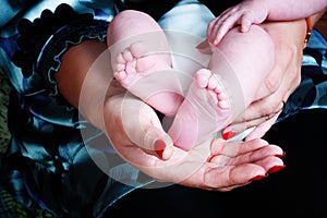 Baby feet and mother hands