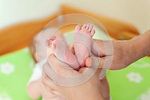 Baby feet and mother hands