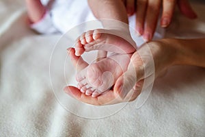 Baby feet and mother hands