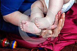 Baby feet and mother hands