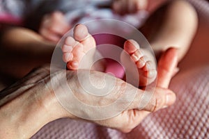 Baby feet and mother hands