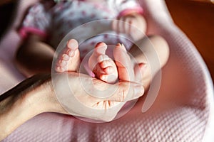 Baby feet and mother hands