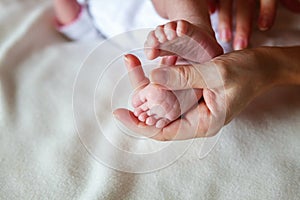 Baby feet and mother hands