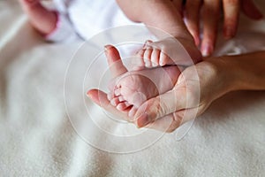 Baby feet and mother hands